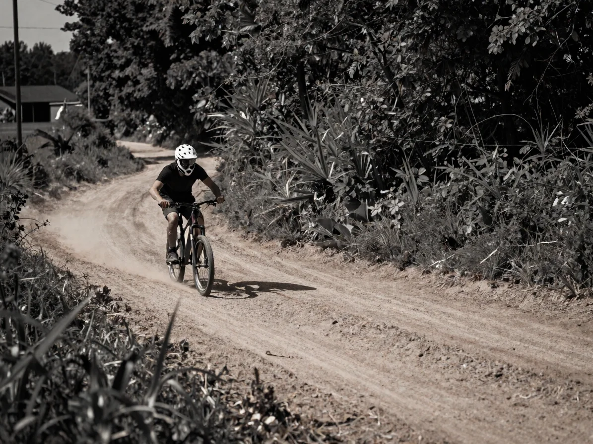 Wide cinematic frame, a rider carving a turn on a dirt path, hand